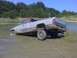 1996 Dodge 1500 - This Dodge pickup is stuck in the mud near a body of water, with trees in the background.