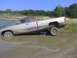1996 Dodge 1500 - A silver pickup truck is stuck in a muddy area, with its front wheels submerged in water and mud. The truck appears to be a 1994 Dodge Ram…