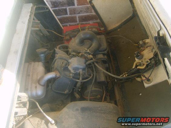 Engine compartment with visible hoses and wiring