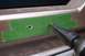 1996 Ford Bronco - Drilling holes in a car's body panel, marked with green tape.