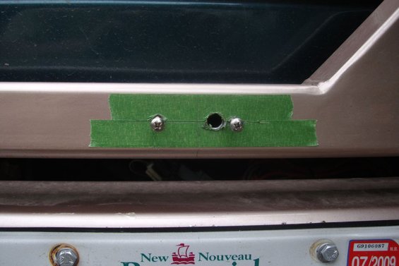 Green tape covers holes drilled for license plate light mounting