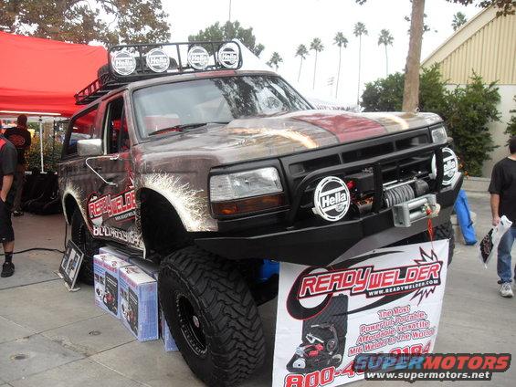 Modified SUV with custom paint, roof rack, winch, and off-road tires