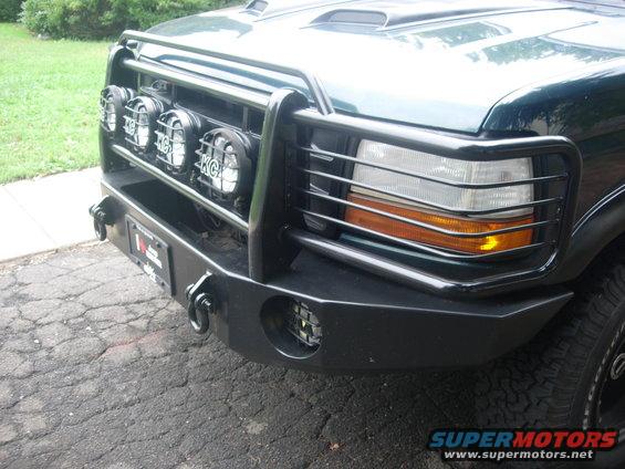 Dark green 1992 Ford Bronco front bumper with KC lights and a brush guard