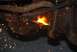 1996 Ford Bronco - Cutting rusty metal suspension part with a torch, sparks flying.