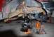 1996 Ford Bronco - The vehicle's front suspension and frame are disassembled and supported by jack stands in a garage.