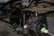 1996 Ford Bronco - Close-up view of the suspension and steering linkage on a vehicle's undercarriage.