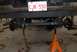 1996 Ford Bronco - The rear suspension and axle of a vehicle are elevated on jack stands for maintenance.
