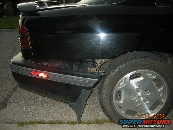 1989 Mazda MX-6 rear quarter panel with damaged bumper and exposed metal