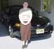 2001 Ford Mustang - A woman stands in front of a black 2001 Ford Mustang in a garage.