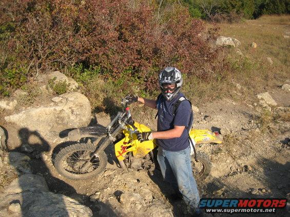1993 Suzuki RMX250 dirt bike with rider on rocky trail