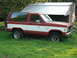 1984 Ford Bronco II - This two-door Ford Bronco II is seen from the front three-quarter angle, parked in a grassy area next to a shed.