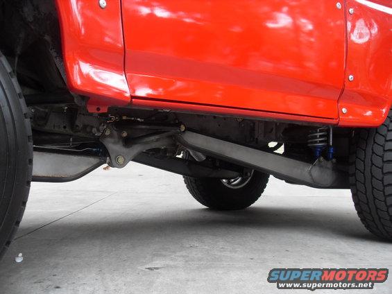 Red SUV chassis with visible suspension components and tires