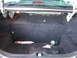 2000 Ford Crown Victoria - The trunk of a car is shown, containing a tube of sealant and a small green canister.