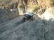 1985 Toyota 4Runner - A modified white SUV navigates a challenging rocky trail in a canyon.