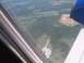 1971 Ford Ranchero - View from an airplane window shows a landscape with an airport and a construction site below.