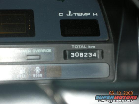Car dashboard with odometer showing 308234 km and temperature gauge