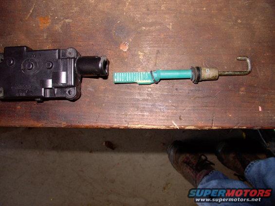 Guess that's why it wasn't working. The actuator was laying in the bottom of the door, having fallen down once the rivet let go. The green hook was still in place(very much separate from the actuator), but the driver's lock wasn't locking or unlocking.