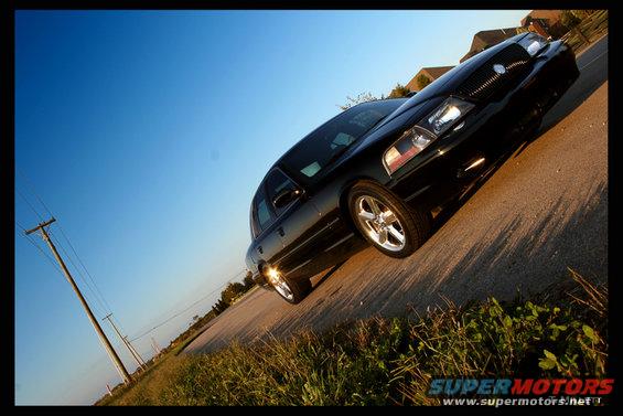 Black 2003 Mercury Marauder parked on a road with a clear blue sky