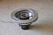 1996 Ford Bronco - A close-up view of a brake rotor and hub assembly, likely a replacement part, resting on a concrete surface.
