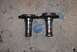 1996 Ford Bronco - Two metal hubs with bolt holes are shown on a concrete surface.