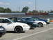 1993 Ford Taurus - Multiple sedans are parked in a row next to a racing track.