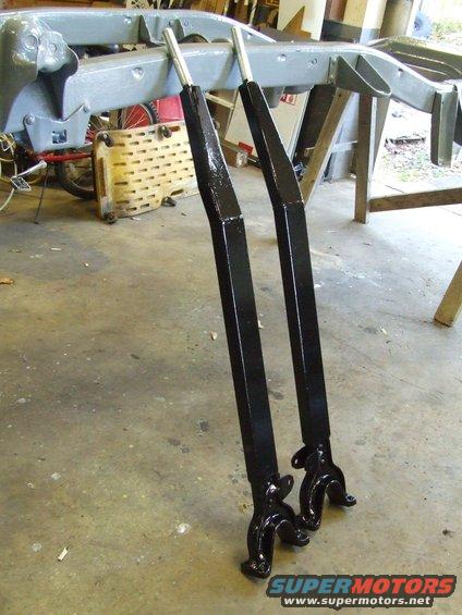 Vehicle frame on stands with two black painted suspension components in front