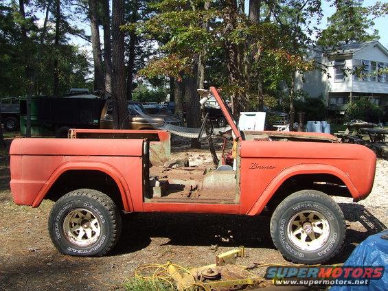Orange 1967 Ford Bronco body, missing doors and top, parked outdoors
