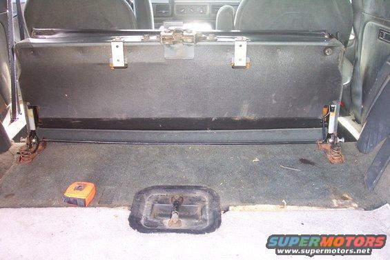 1992 Ford Bronco back seat folded up, showing carpet and metal brackets