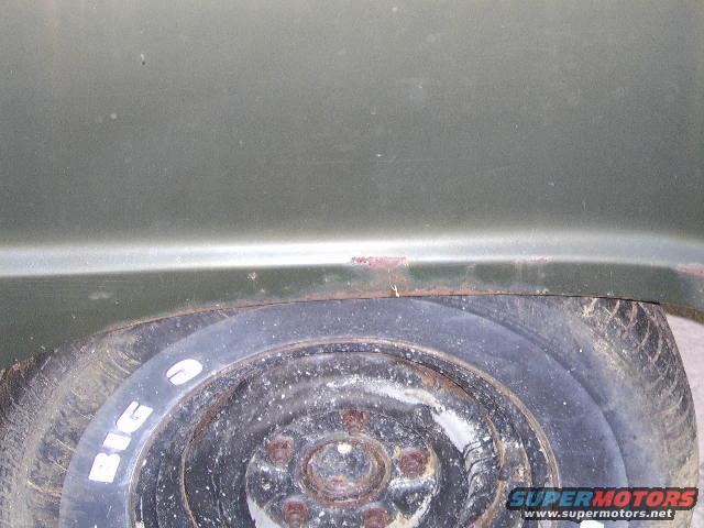 Green 1976 Ford Bronco rear fender with spare tire showing 'BIG O' text
