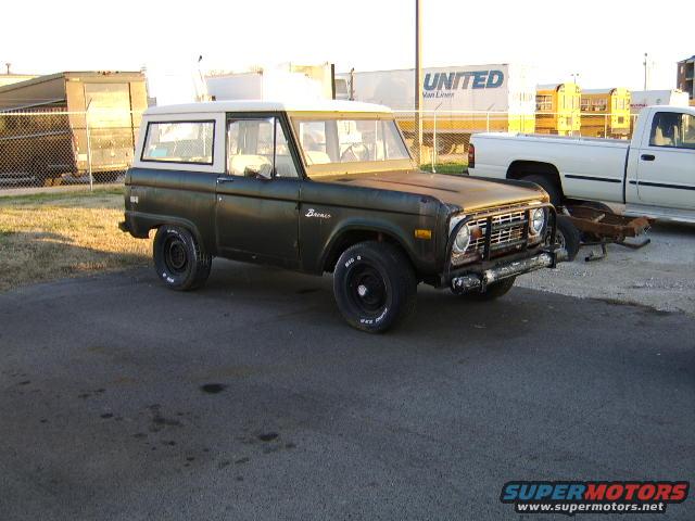 1976 Ford Bronco, dark green with white hardtop, parked outdoors