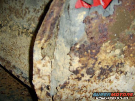 close-up of heavily rusted metal, possibly from a vehicle undercarriage