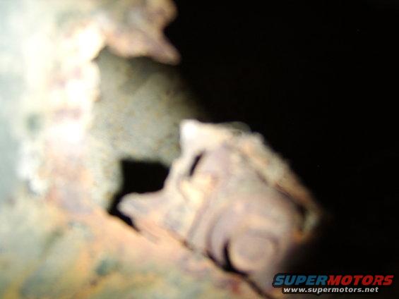 Close-up of heavily rusted metal, possibly a vehicle component