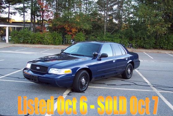 Blue 2001 Ford Crown Victoria parked in a lot