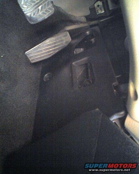 Car interior showing brake and gas pedals. Supermotors.net logo visible