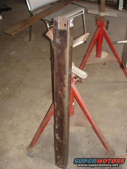 metal beam supported by red jack stands