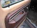 1978 Ford F-250 - Interior door panel detail showing wear and tear on the trim and handle area.