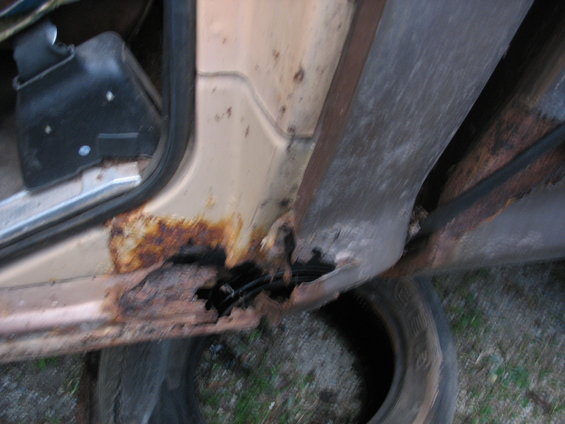 Rusted door sill and interior panel of a vehicle