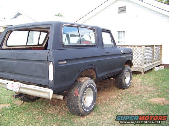 Black Ford Bronco, rear 3/4 view. Has aftermarket wheels and tires. License plate reads 086 SJW