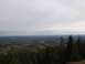 2008 Honda RANCHER - A wide view of a forest in autumn, with a lake visible in the distance under a cloudy sky.