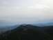2008 Honda RANCHER - A scenic view of rolling hills and distant mountains under a hazy sky.