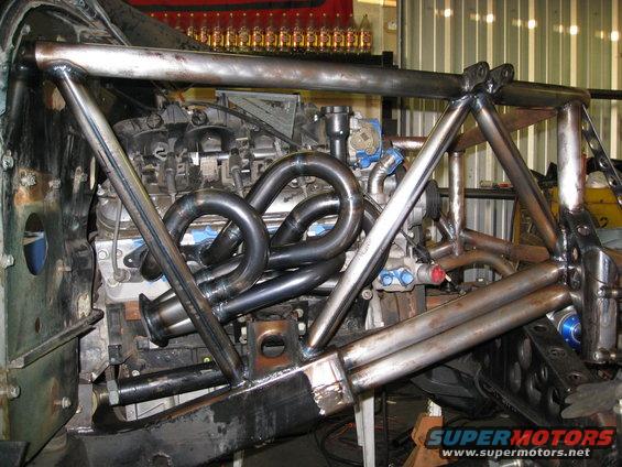 custom roll cage over engine with headers