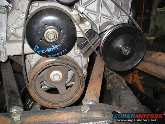 Engine belt pulleys with blue writing '03 ESC BAT A04711' on one