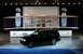 2004 Lincoln Aviator - A black SUV is displayed in front of a replica of the Wright Flyer at a Centennial of Flight event.
