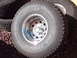1978 Ford Bronco - Close-up of Pro Comp All Terrain tires mounted on shiny chrome wheels.