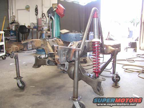 Vehicle frame and suspension assembly on casters in a workshop