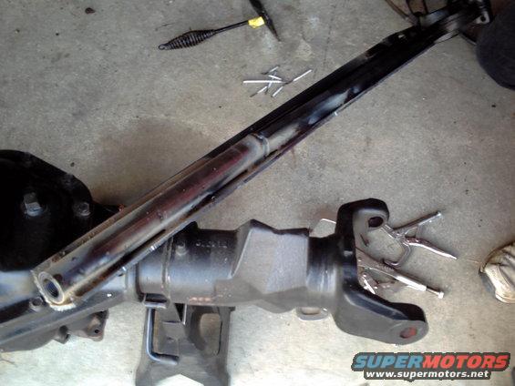 Vehicle axle assembly on jack stands with tools nearby