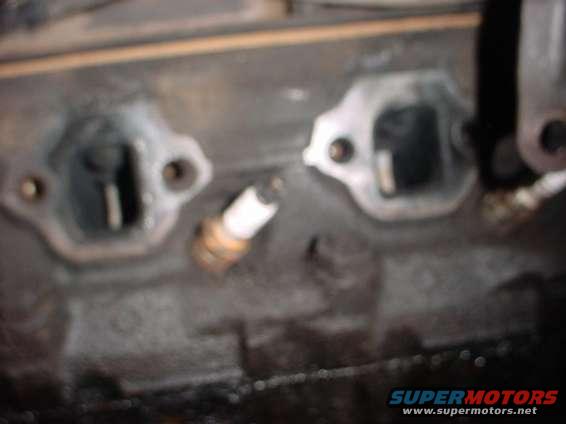 Engine block with spark plug and exhaust ports