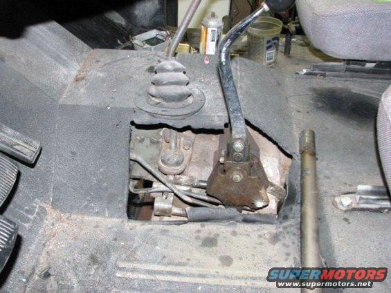 Interior view of two gear shifters and pedals in a vehicle