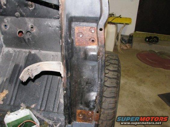 rusted body panel and tire of a vehicle