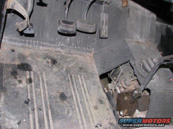 Vehicle interior floor with pedals and transmission shifter mechanism